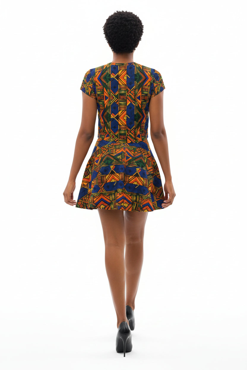 Woman wearing a colorful patterned crop top and denim skirt on a white background