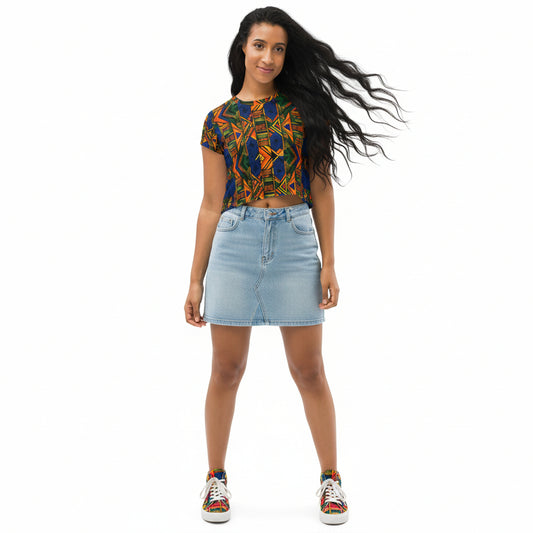 Woman wearing a colorful patterned top and denim skirt on a white background
