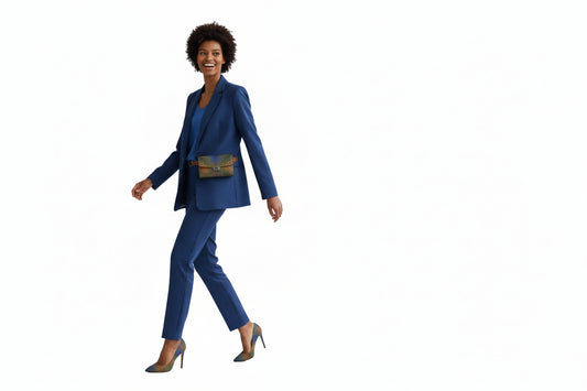Woman in a blue suit holding a colorful bag on a white background