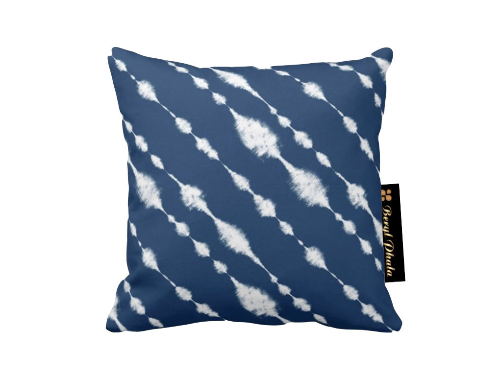 Blue pillow with white abstract pattern on a white background