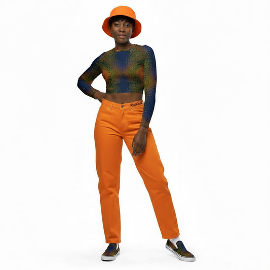 Wearing same crop top with orange jeans with the KhuKhuZ logo on the right side of the jeans and wearing same fabric print as the slip on canvas shoes