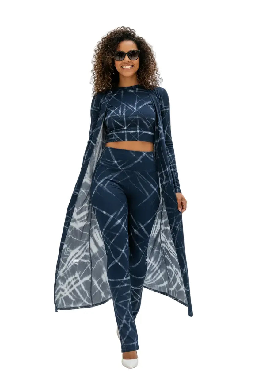 Woman wearing a navy blue long-sleeve crop top and skarter skirt set on a white background