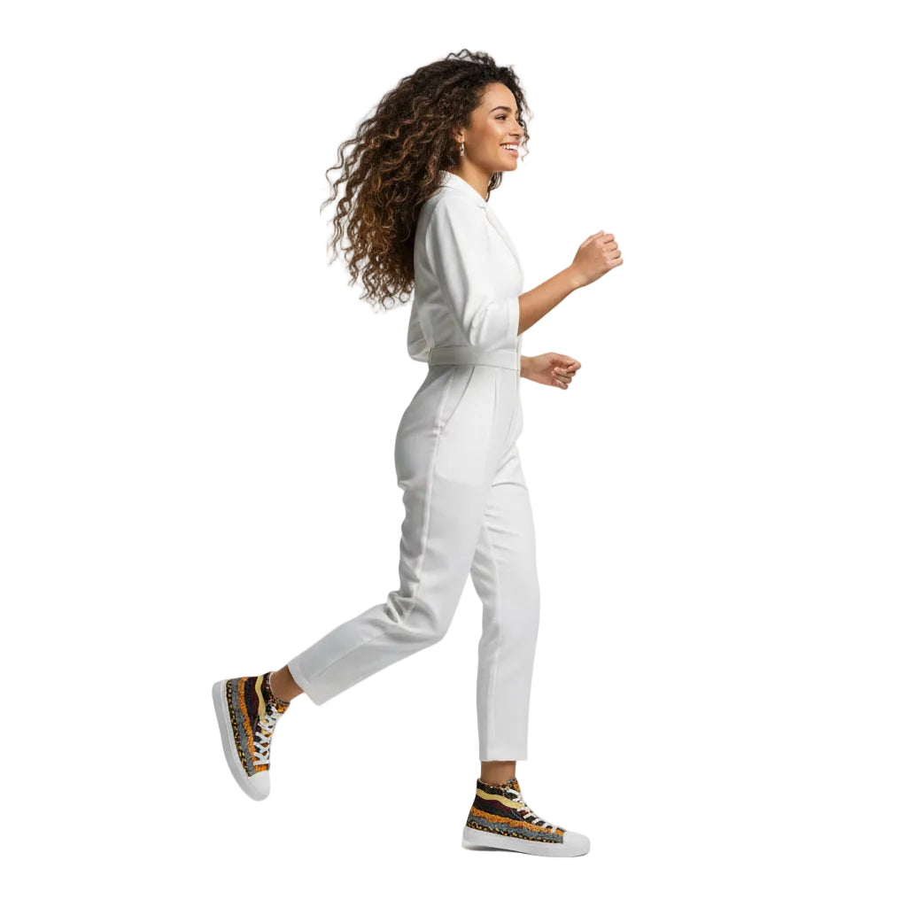 Woman in a white outfit with colorful sneakers walking on a white background
