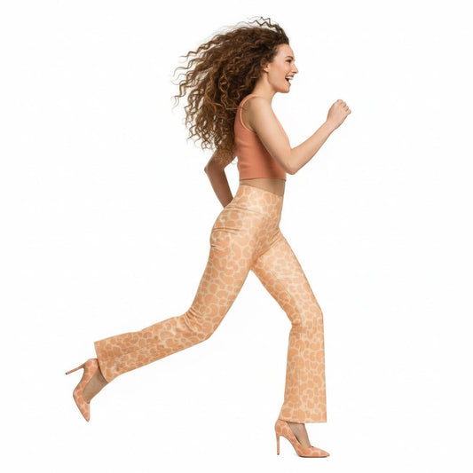 Woman wearing a gray sleeveless top and orange patterned pants on a white background