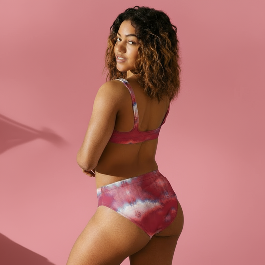 Woman wearing a pink tie-dye bikini set against a neutral background