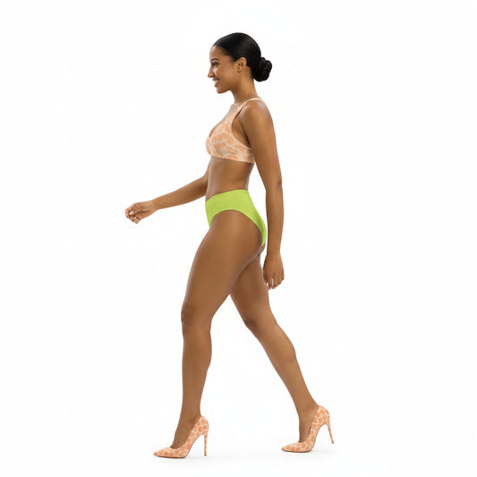 Woman wearing a patterned bikini top and bright green bottoms on a white background