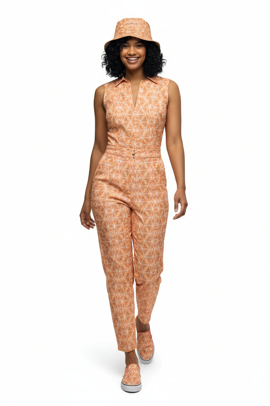 Woman wearing a patterned jumpsuit and hat on a white background