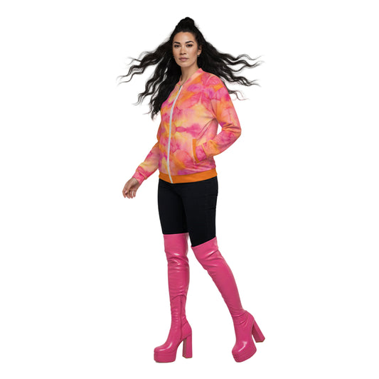 A woman wearing a vibrant orange and pink floral print unisex bomber jacket with a zipper and a hood.