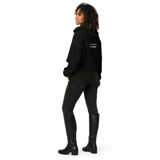Person wearing a black hoodie with 'I deserve the BEST' text on the back, standing against a white background.