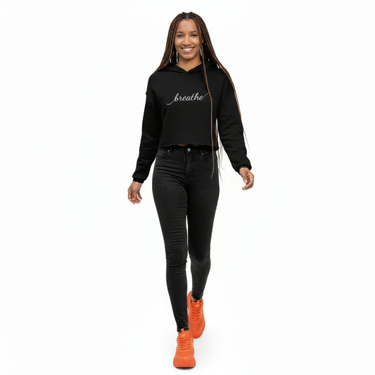 Woman wearing a black hoodie with 'breathe' text on a white background