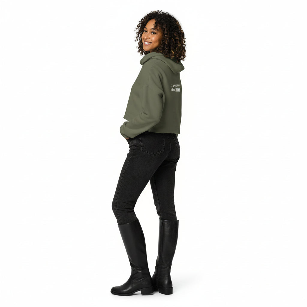 Woman wearing a green hoodie and black pants on a white background