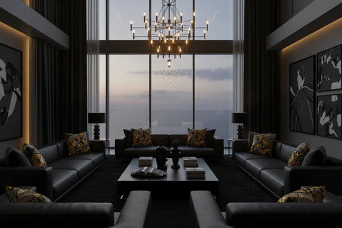 Modern living room with dark furniture, large windows, and a chandelier.