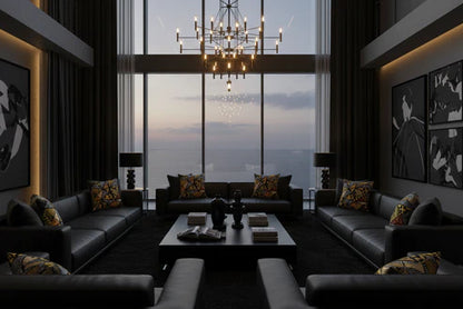 Modern living room with dark furniture, large windows, and a chandelier.