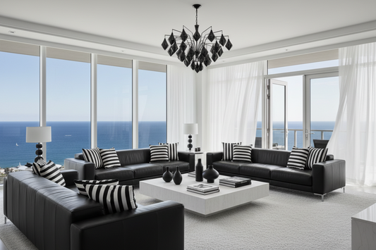 Modern living room with black leather sofas, striped cushions, and a chandelier.