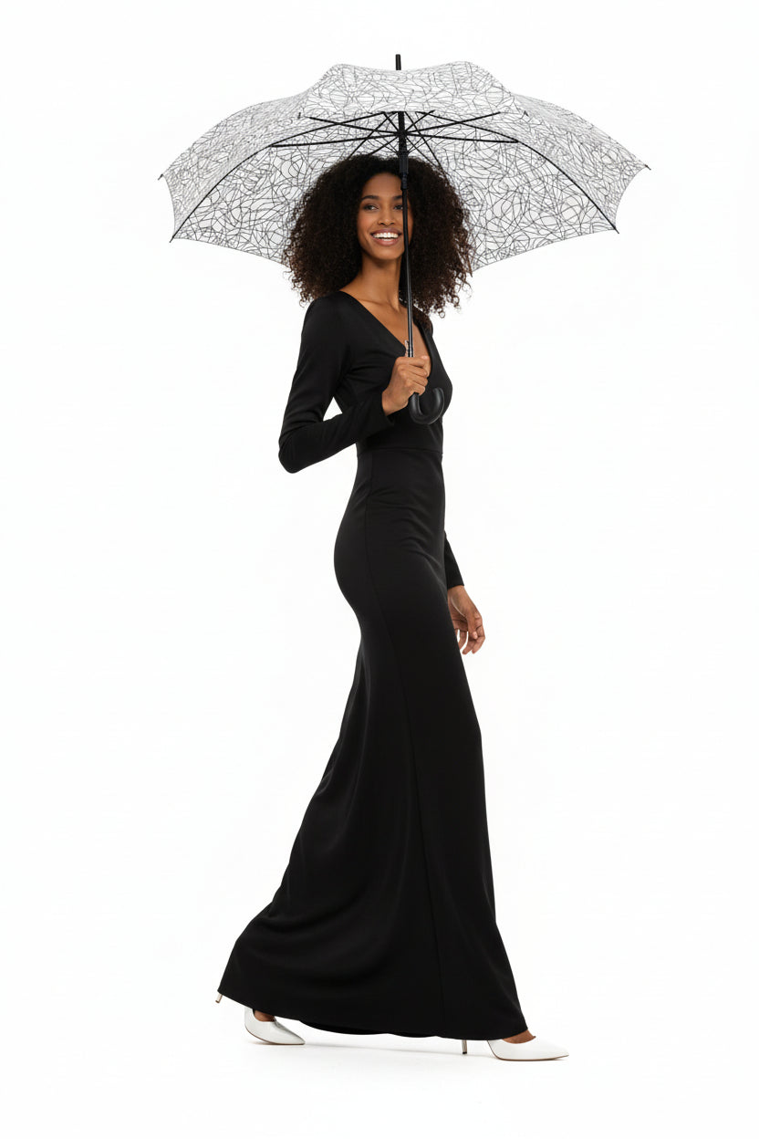 Woman holding a KhuKhuZ patterned umbrella wearing a matching outfit on a white background