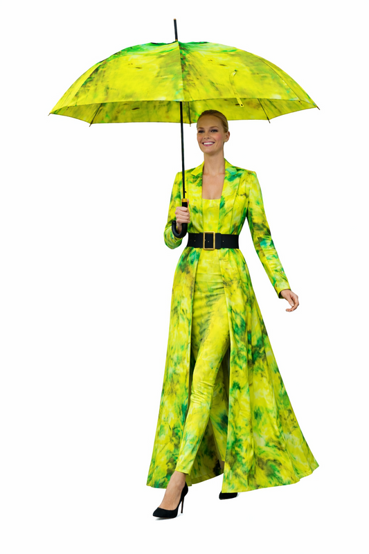 Woman in a bright yellow and neon green dress holding a matching umbrella on a white background