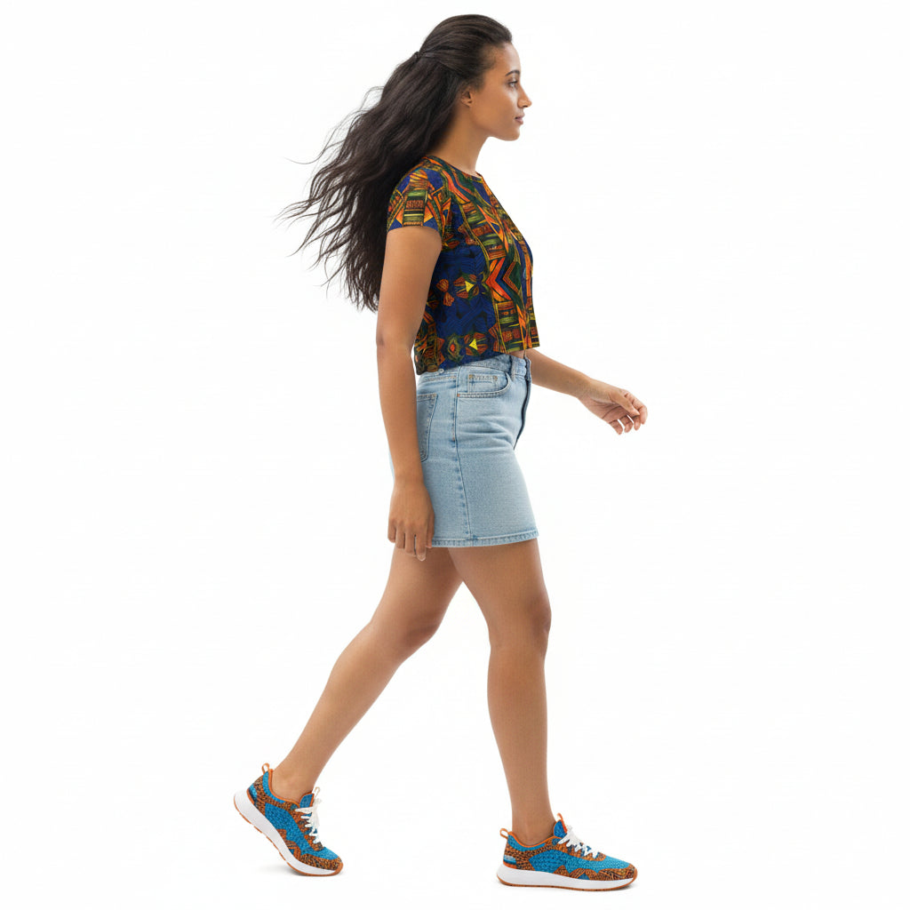 Woman wearing a colorful top and denim shorts on a white background