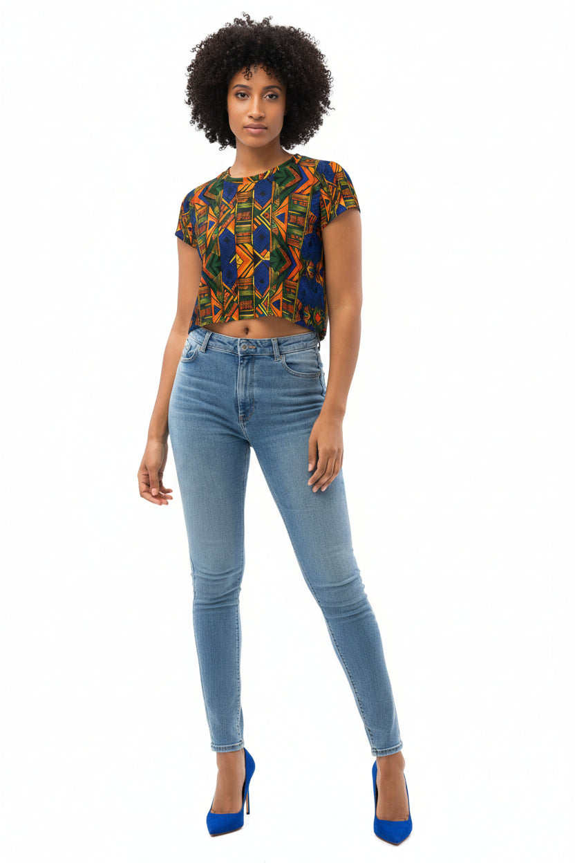 Woman wearing a colorful patterned top and denim skirt on a white background