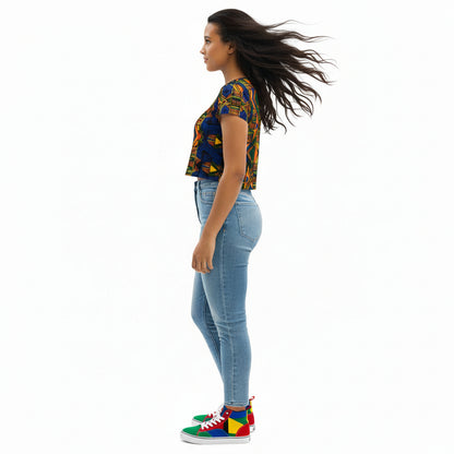 Woman wearing a colorful patterned crop top and blue jeans on a white background
