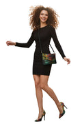 Woman in a black dress with a colorful handbag walking on a city street.