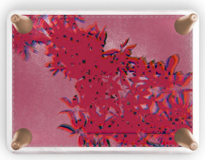 A square footstool with rounded corners and four brass grommets, featuring a vibrant pink and red abstract floral pattern printed on its surface, shown against a plain white background.