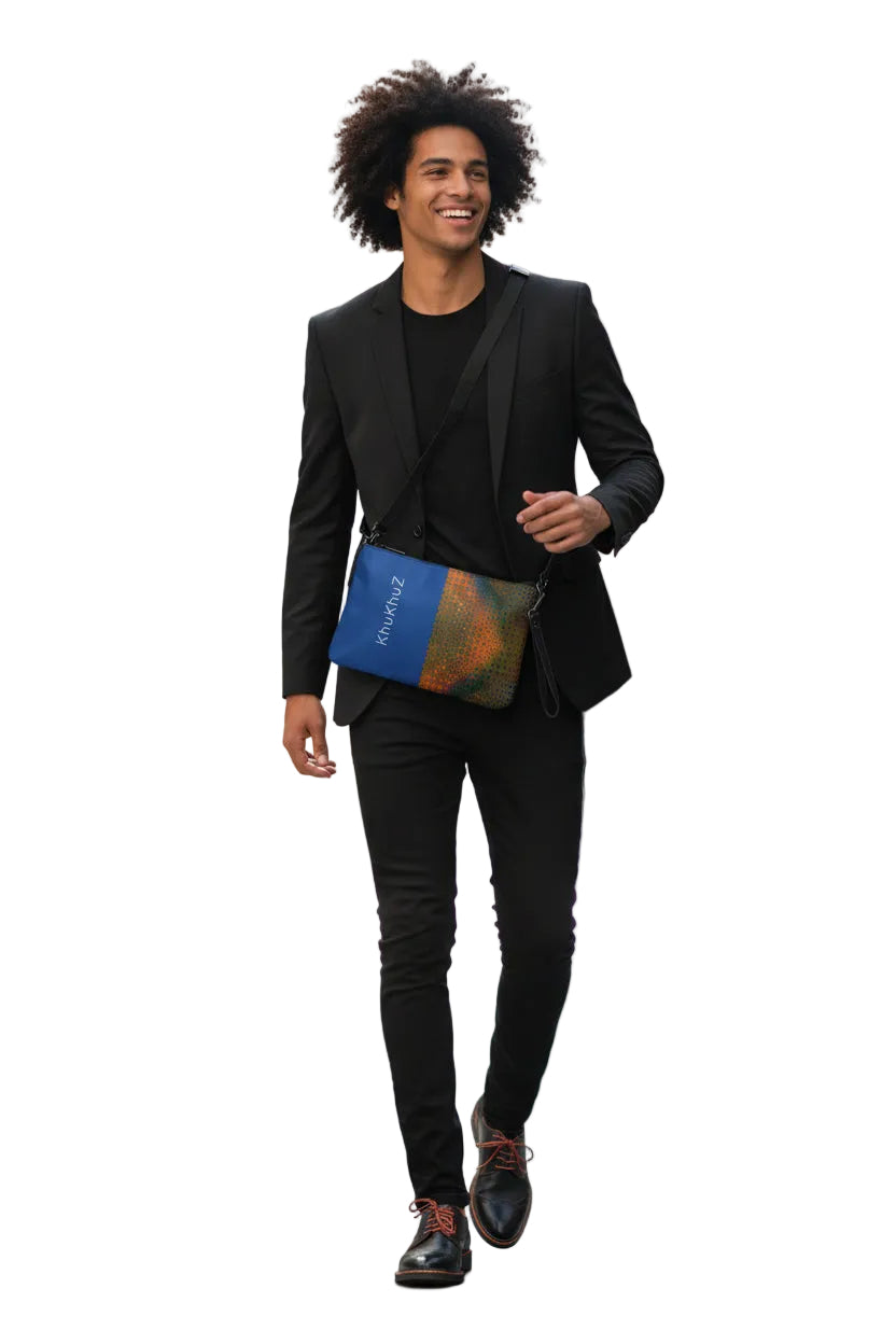Man in a black suit walking outdoors with a khukhuz colorful bag