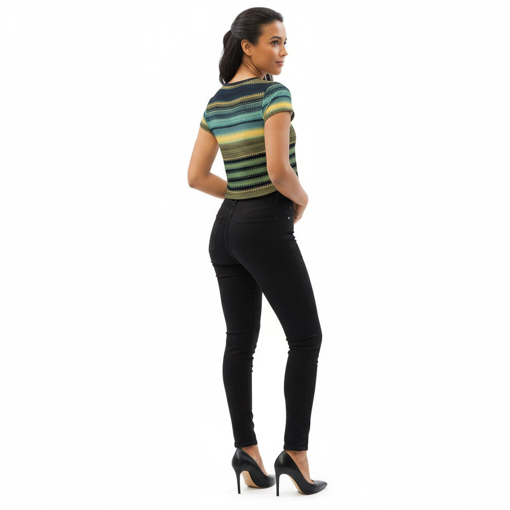 Woman wearing a patterned unisex crop tee with black jeans and black high heels 