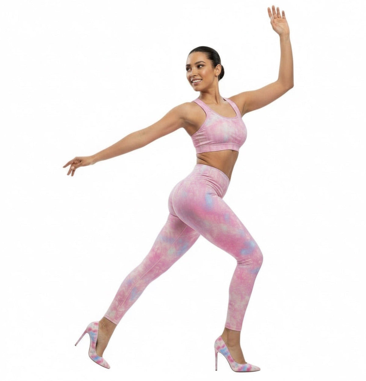 Woman wearing a KhuKhuZ pink tie-dye athletic outfit on a white background