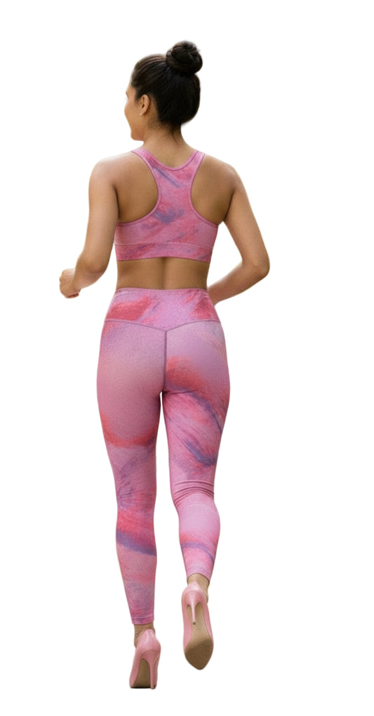 Woman wearing a pink and purple patterned athletic outfit on a white background