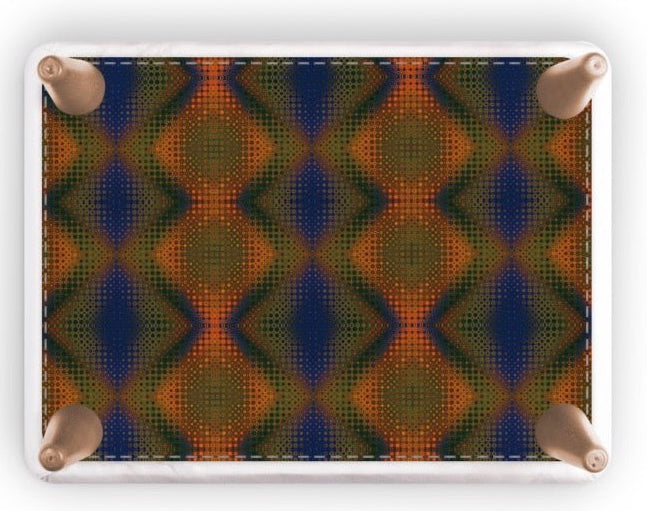 A rectangular footstool with rounded corners and four wooden feet, featuring a colorful geometric pattern of blue, green, and orange diamonds, shown on a white background.