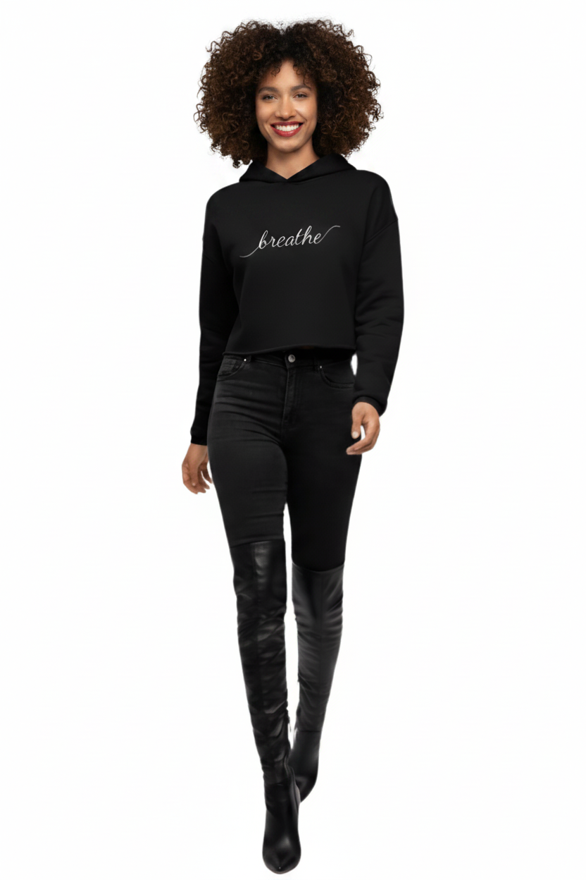 Woman wearing a black KhuKhuZ 'breathe' crop hoodie on a white background