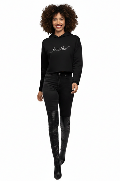 Woman wearing a black KhuKhuZ 'breathe' crop hoodie on a white background