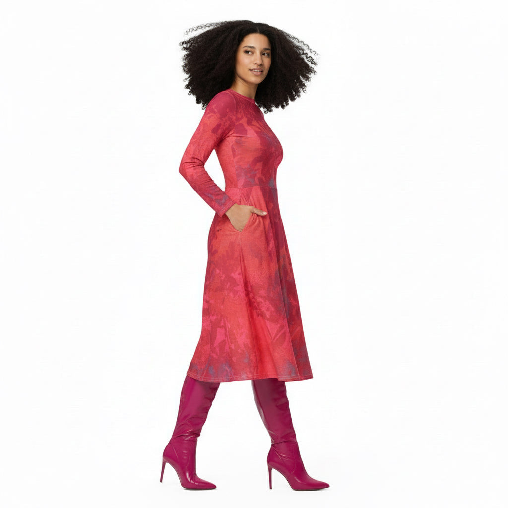 Woman wearing a red patterned dress and pink high-heeled boots on a white background