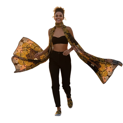 Woman wearing a patterned scarf and black outfit on a white background