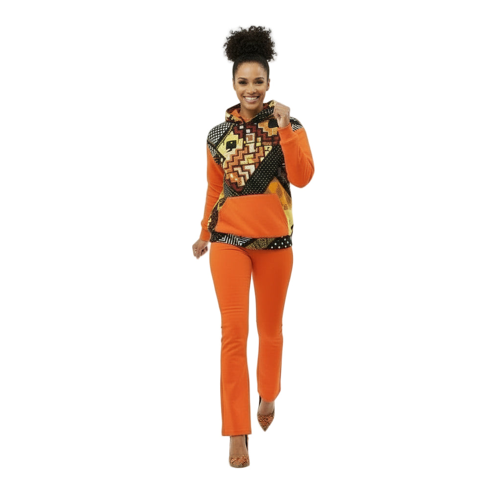Woman wearing an orange and patterned outfit on a white background
