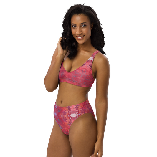 Woman wearing a pink and purple patterned bikini on a white background