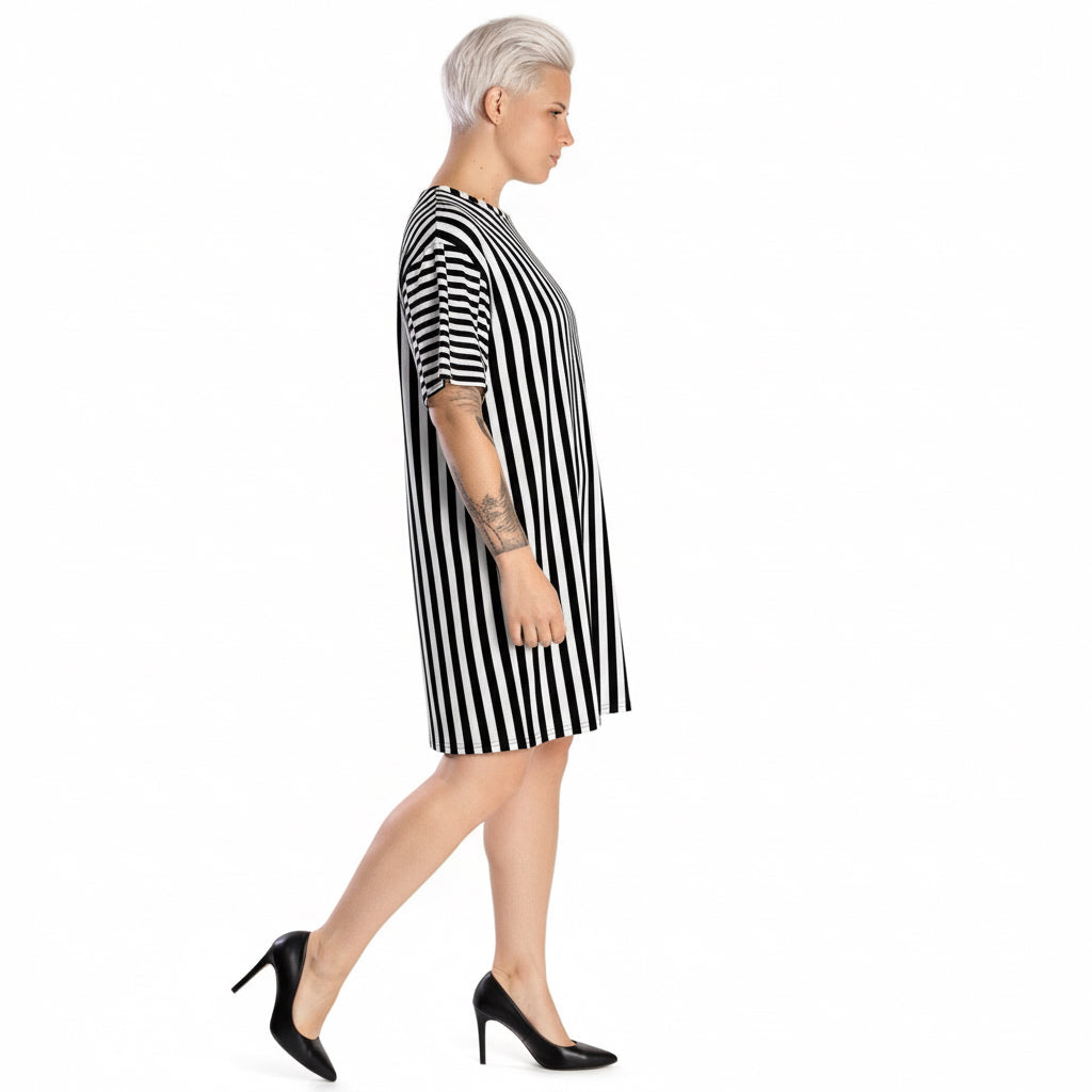 Person wearing a black and white striped dress on a white background
