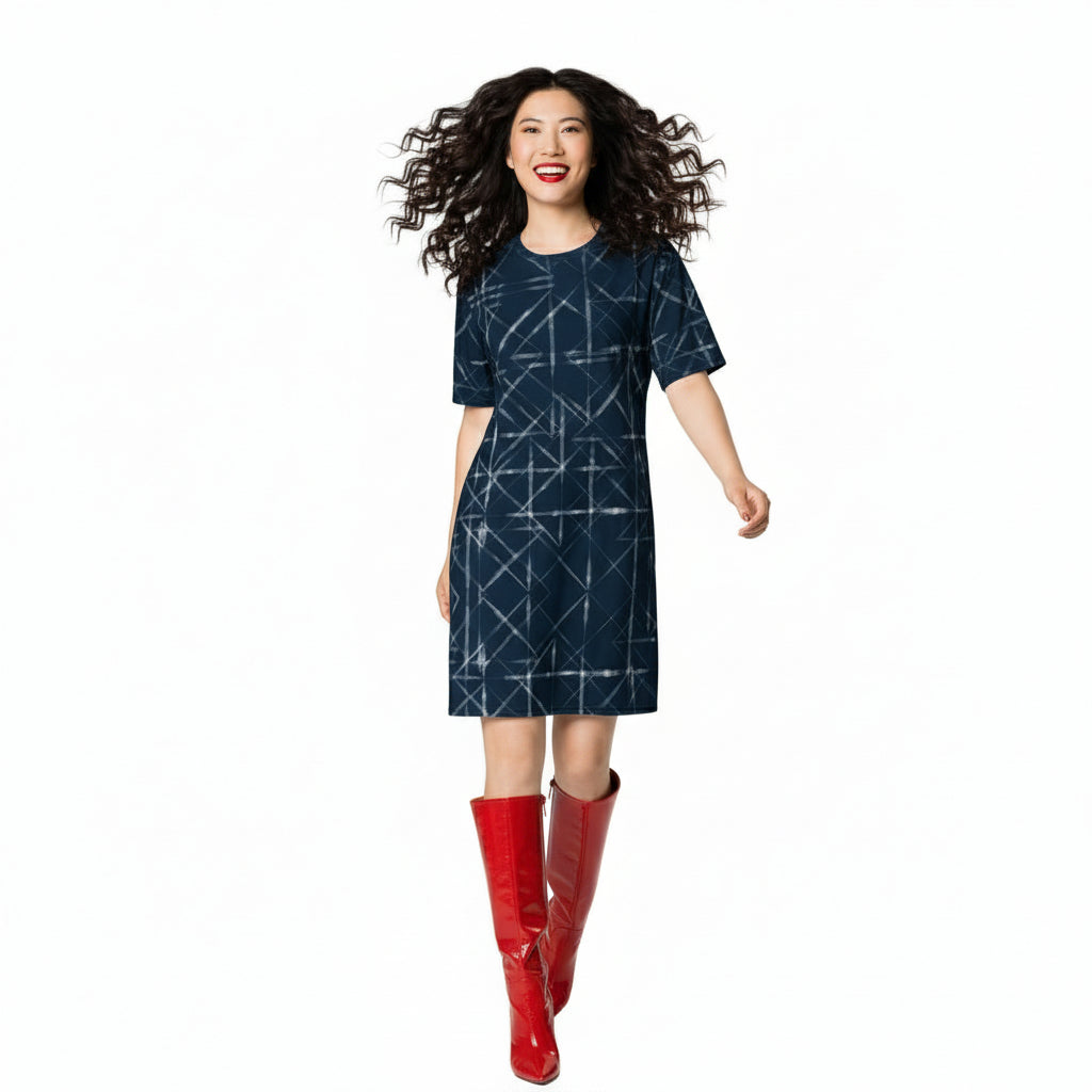 Woman wearing a navy blue dress with white geometric pattern on a white background