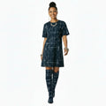 Woman wearing a blue geometric patterned dress on a white background