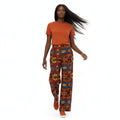 Person wearing a rusty t-shirt and patterned pants on a white background