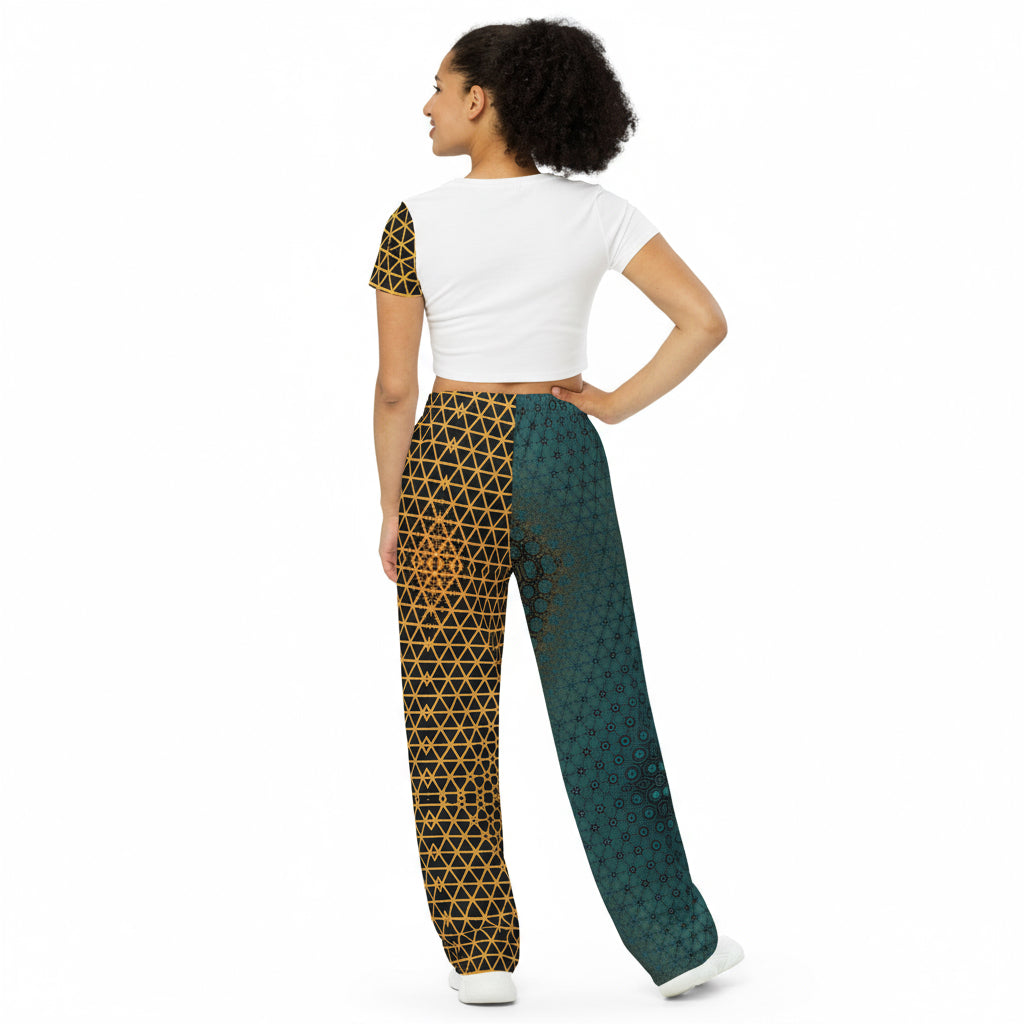 Woman wearing a white top and patterned pants on a white background