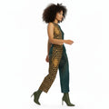A person wearing unisex wide-leg pants with a floral pattern on the right side and a solid color pattern on the left side.
