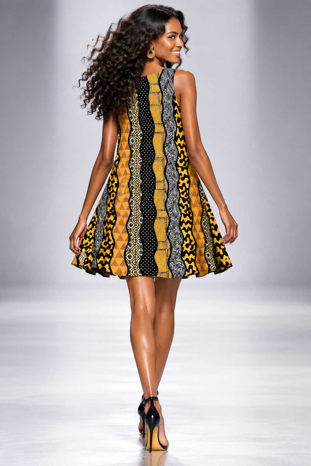 A sleeveless A-line dress featuring a bold vertical pattern of wavy stripes in black, yellow, and white with various traditional African wax print motifs, shown on a plain white background.