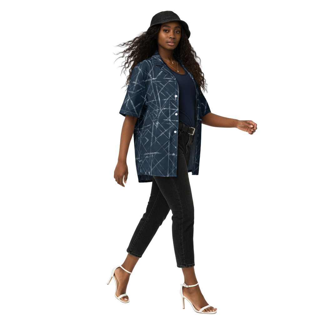 A person wearing a navy blue button-up shirt with a geometric pattern and a black bucket hat.