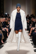 A dome-shaped beanie hat featuring an all-over indigo blue and white tie-dye circular pattern, worn by a runway model