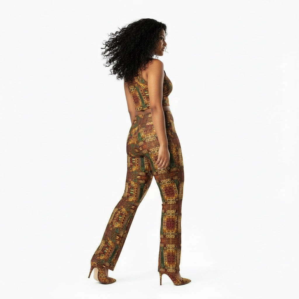 Woman wearing patterned pants and a white top on a white background