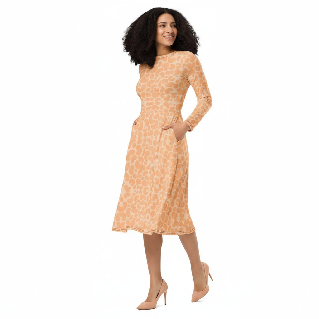 Woman wearing KhuKhuZ peach fuzz patterned dress on a white background