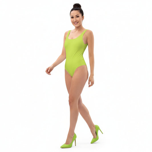 Woman wearing a bright green swimsuit on a white background