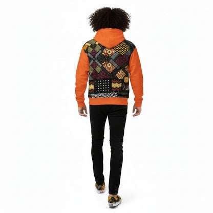 Person wearing a colorful patterned hoodie with an orange sleeve on a white background