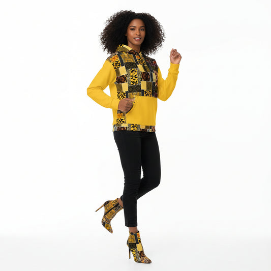 Man wearing a yellow hoodie with a colorful patchwork pattern on a white background